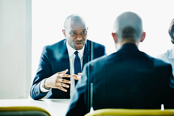 Businessman leading discussion during meeting with colleagues in office conference room